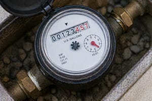 Close-up of water meter dial used to detect hidden plumbing leaks