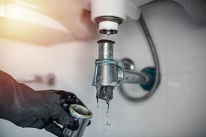 Removing clogged debris from sink drain pipe causing blockage