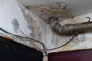 Severe ceiling damage and rusted pipe caused by long-term hidden water leak